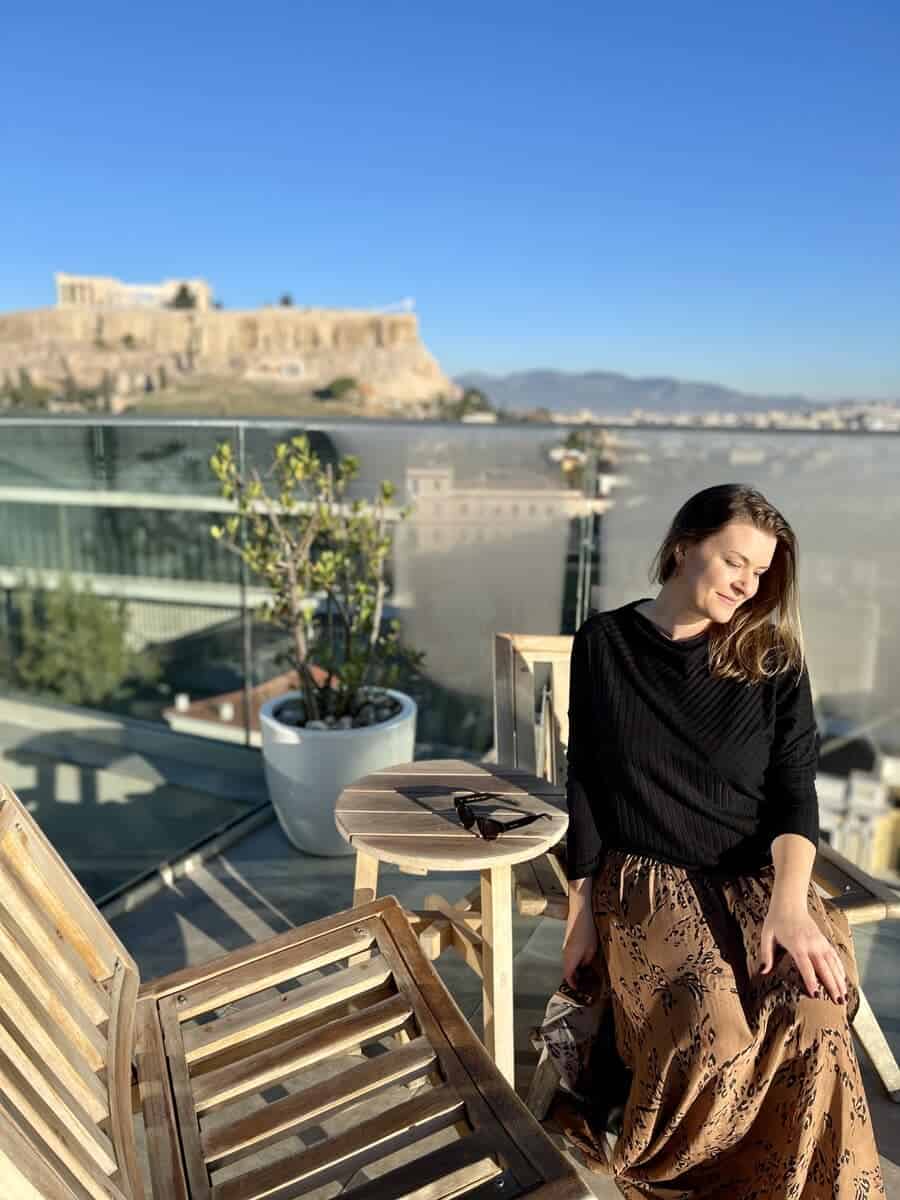 a women sitting alone on a rooftop in Greece.