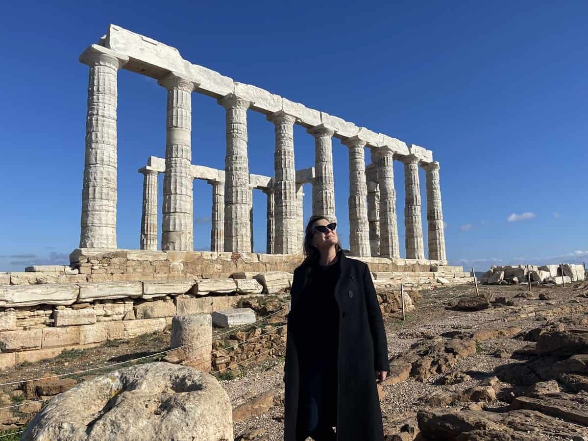 A single woman in from of Temple of Poseidon